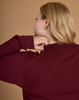 Close up back view of Juliet wearing the Red Wine Long Sleeve Burly Tee 