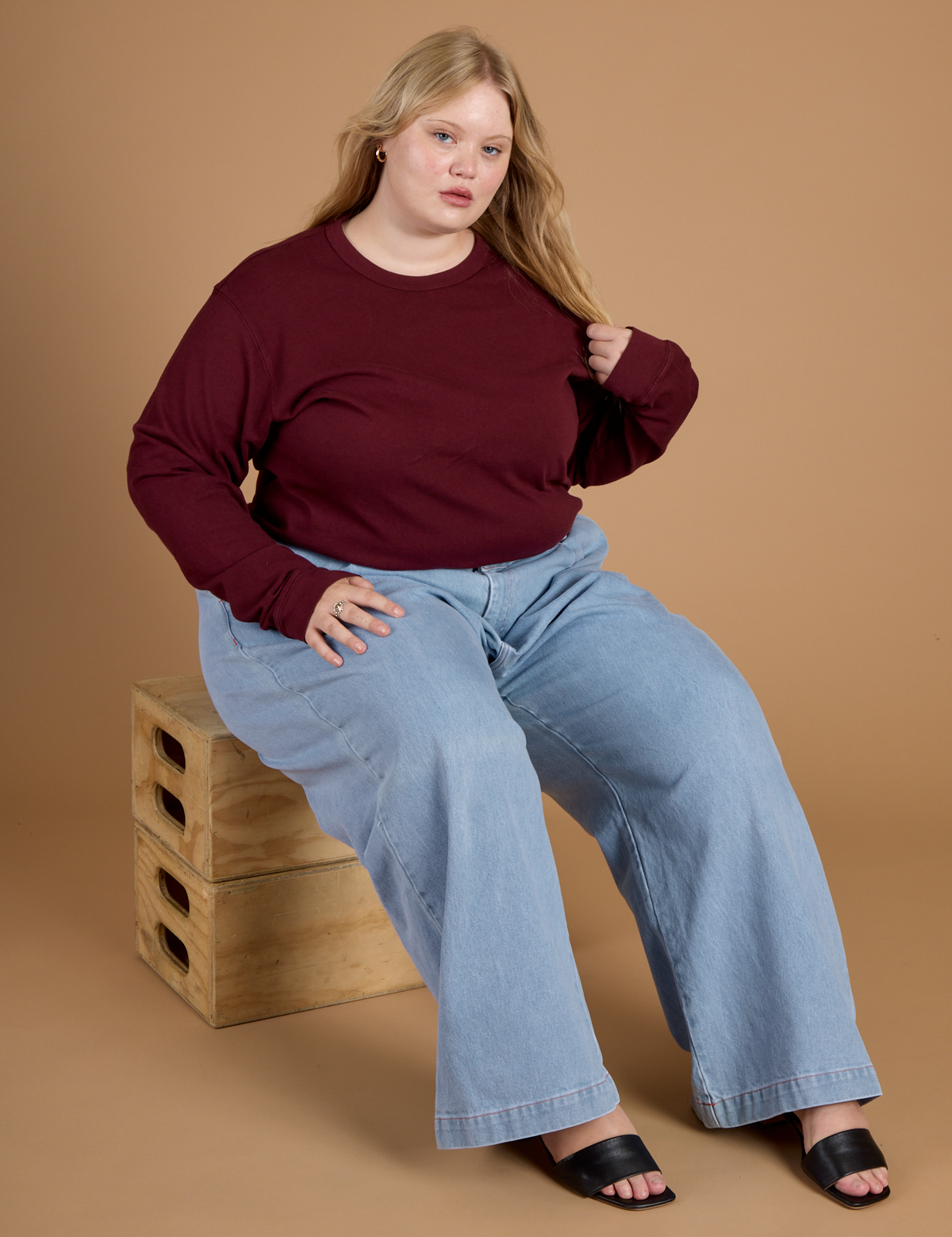 Juliet wearing the Red Wine Long Sleeve Burly Tee with Light Wash Wide Leg Denim Trousers