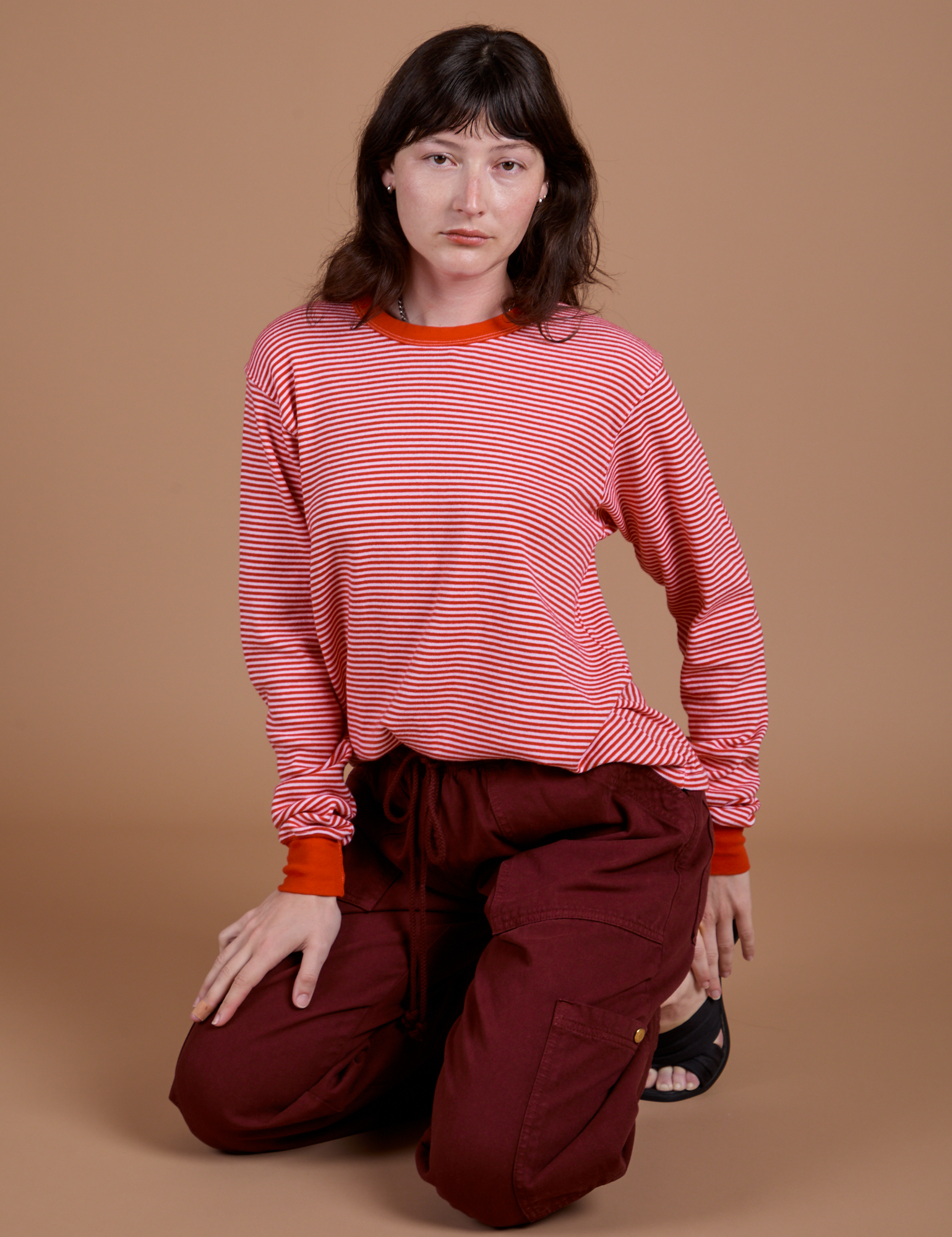 Alex is wearing Long Sleeve Burly Tee in Red/White Stripe