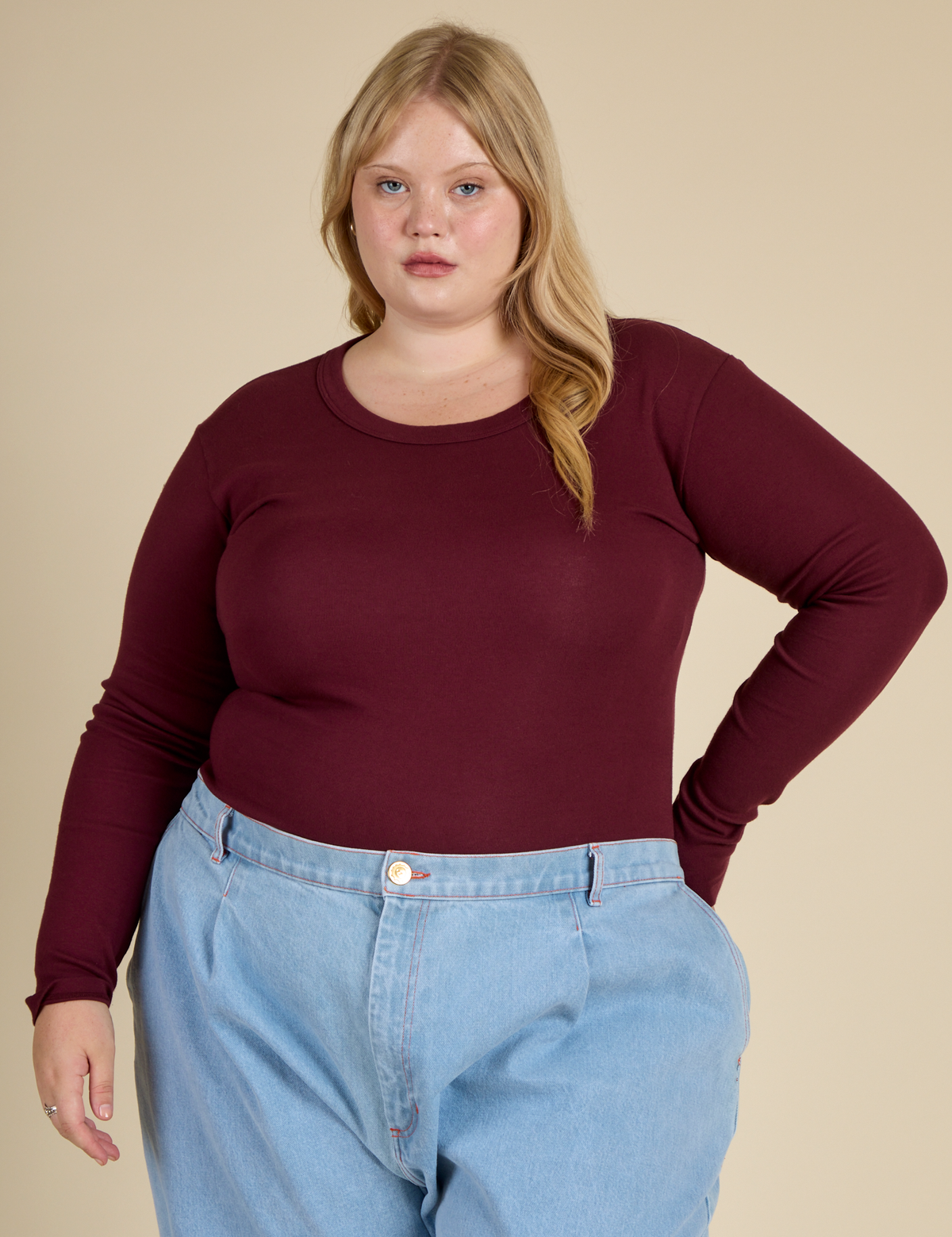 Juliet wearing the Red wine Long Sleeve Baby Tee tucked in
