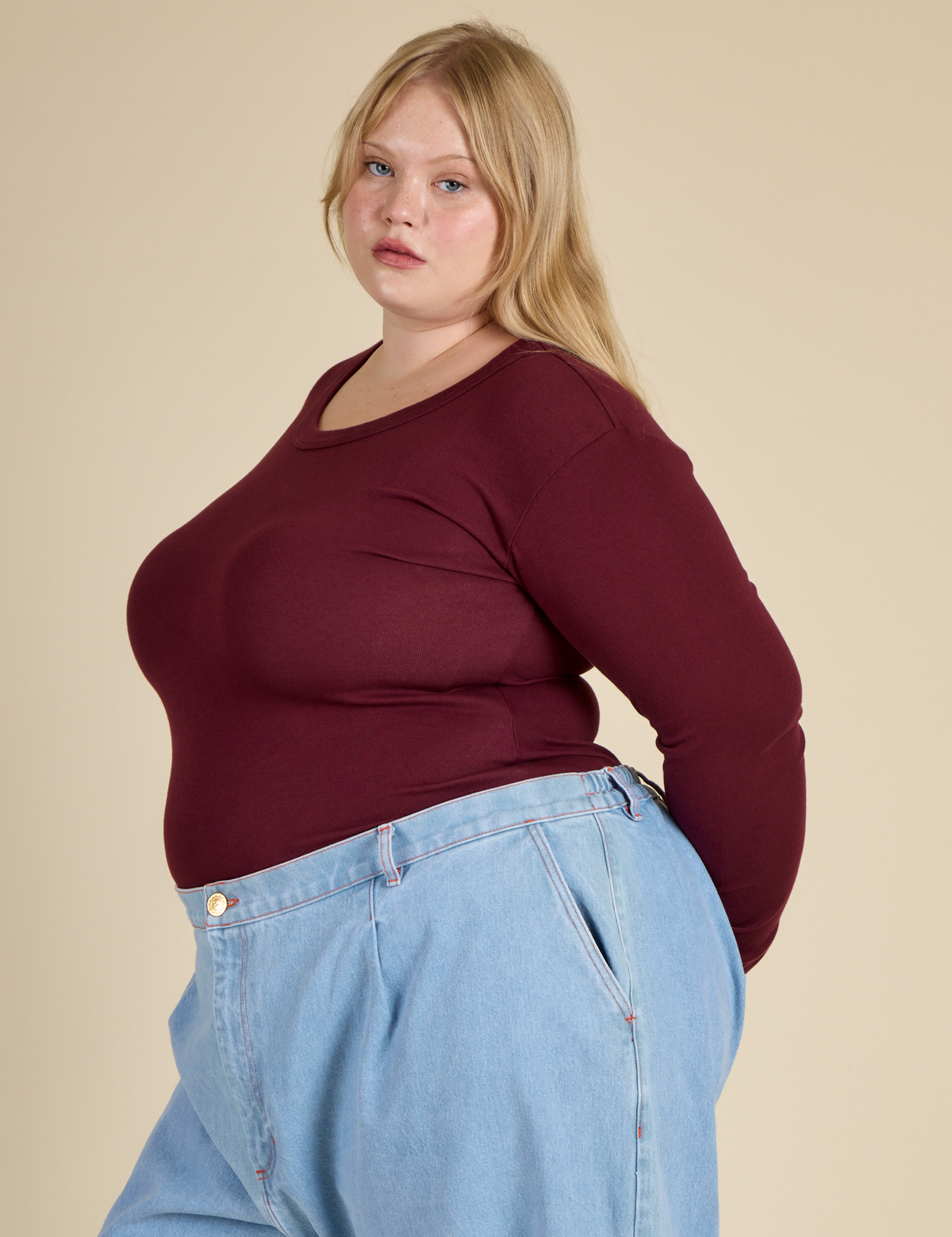 Angled Side View of Juliet in the Red Wine Long Sleeve Baby Tee