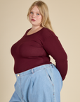 Angled Side View of Juliet in the Red Wine Long Sleeve Baby Tee