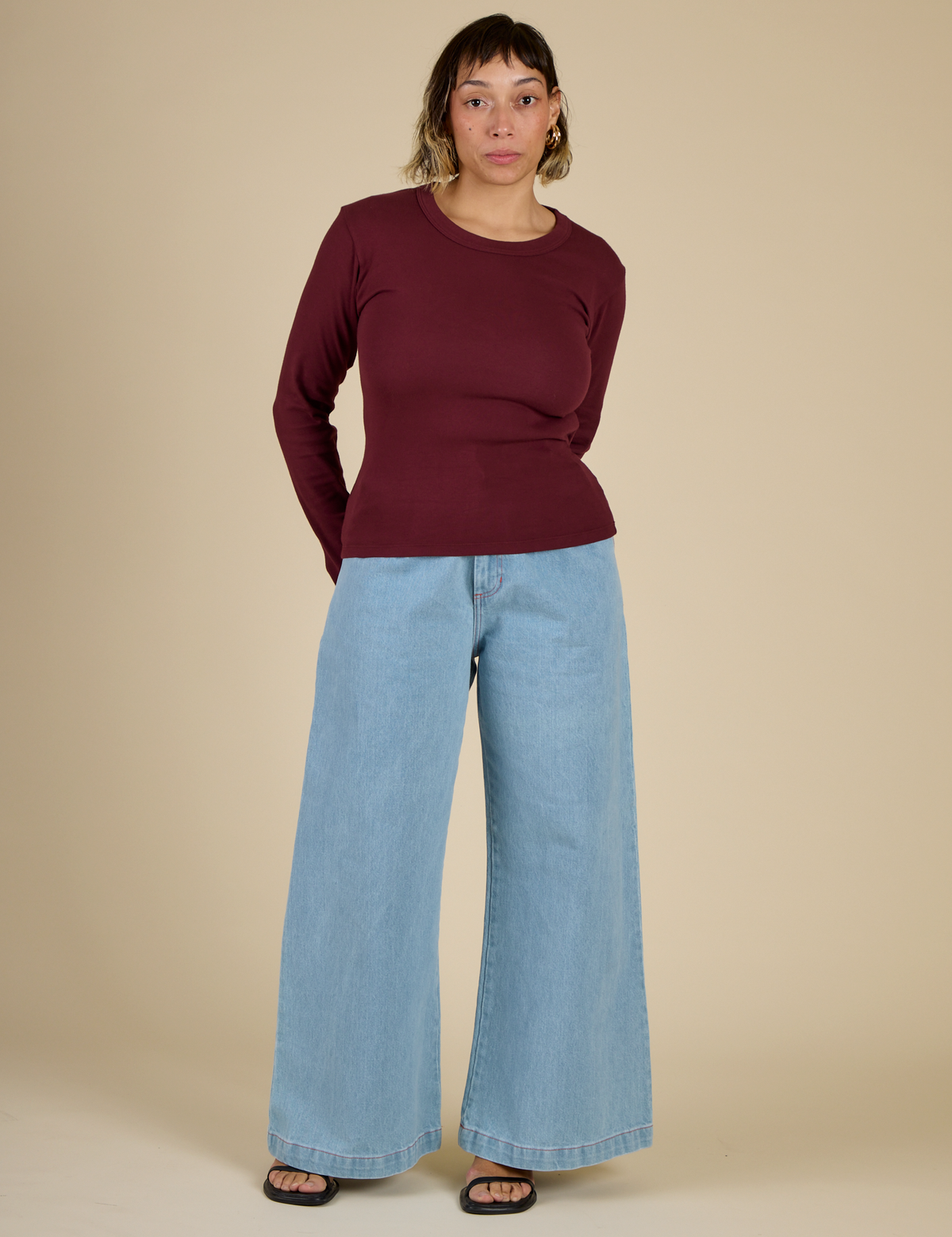 Tiara wearing the Red Wine Long Sleeve Baby Tee with Light Wash Wide Leg Denim Trousers