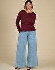 Tiara wearing the Red Wine Long Sleeve Baby Tee with Light Wash Wide Leg Denim Trousers