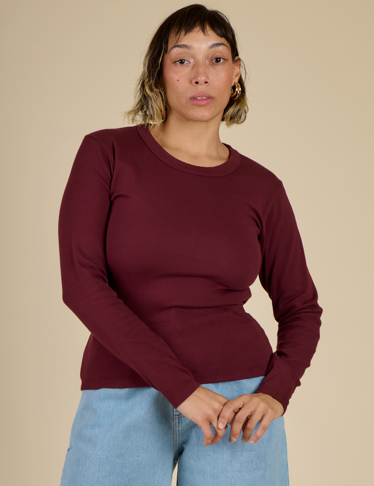 Tiara is 5'4" and wearing XS Red Wine Long Sleeve Baby Tee
