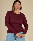 Tiara is 5'4" and wearing XS Red Wine Long Sleeve Baby Tee