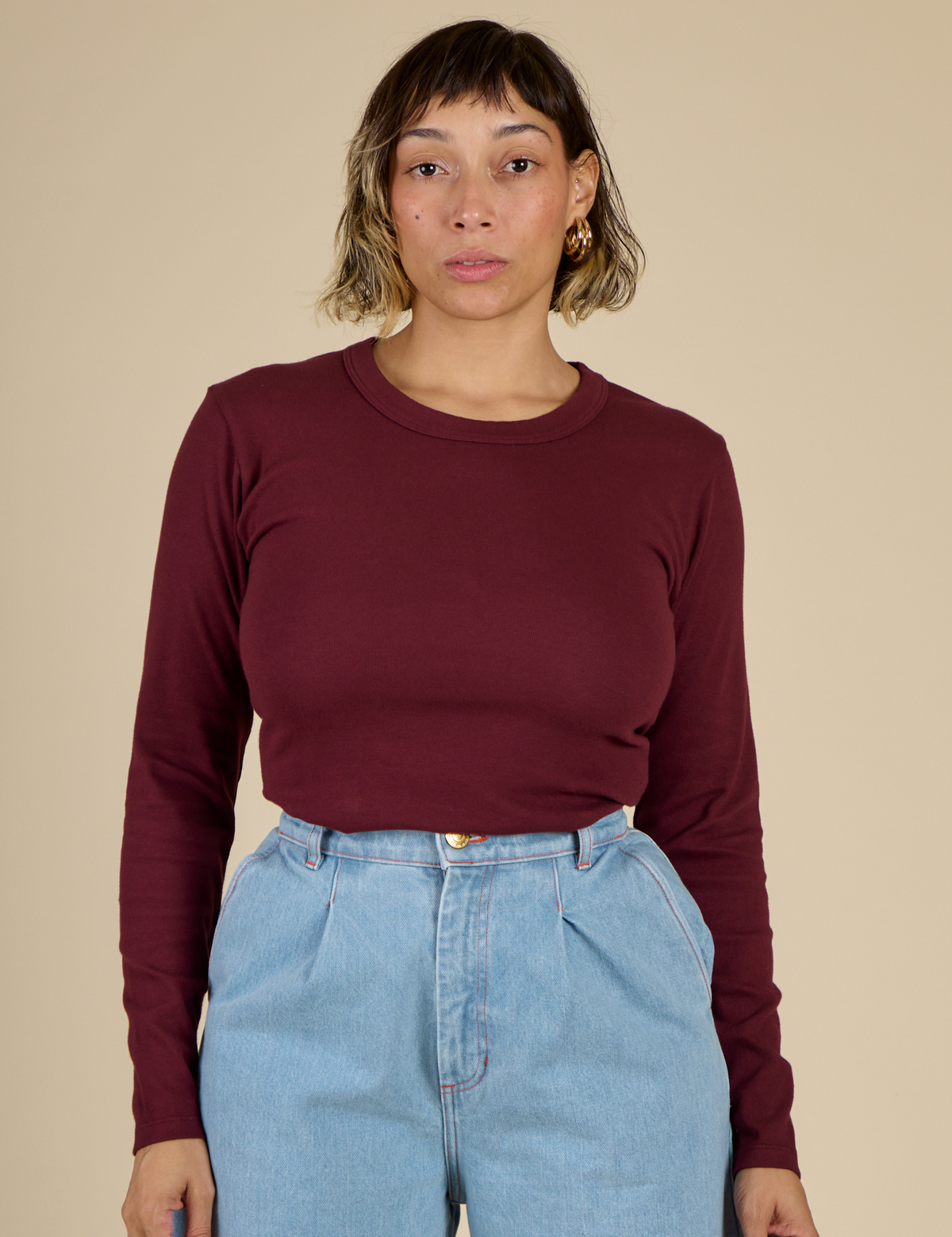 Mika wearing the Red wine Long Sleeve Baby Tee tucked in