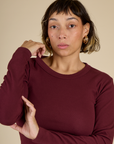 Close up of Tiara in the Red Wine Long Sleeve Baby Tee