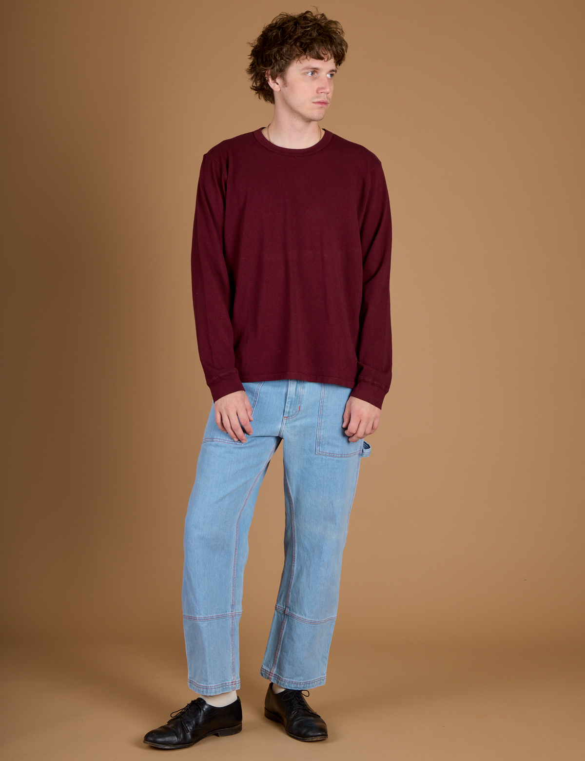Quinn is wearing the Red Wine Long Sleeve Burly Tee with the Light Wash Carpenter Jeans
