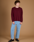 Quinn is wearing the Red Wine Long Sleeve Burly Tee with the Light Wash Carpenter Jeans