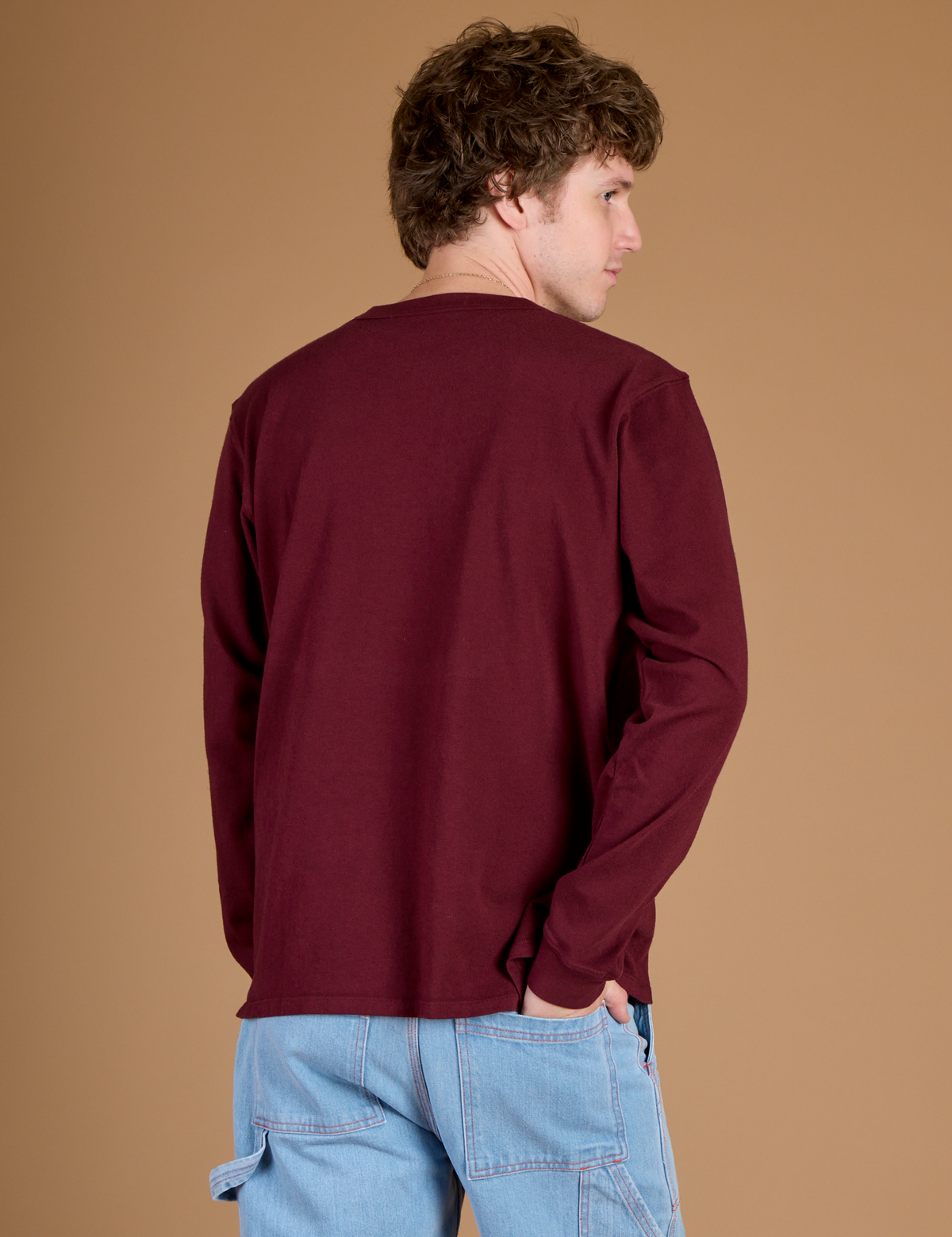 Angled back view of the Red Wine Long Sleeve Burly Tee on Quinn