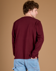 Angled back view of the Red Wine Long Sleeve Burly Tee on Quinn
