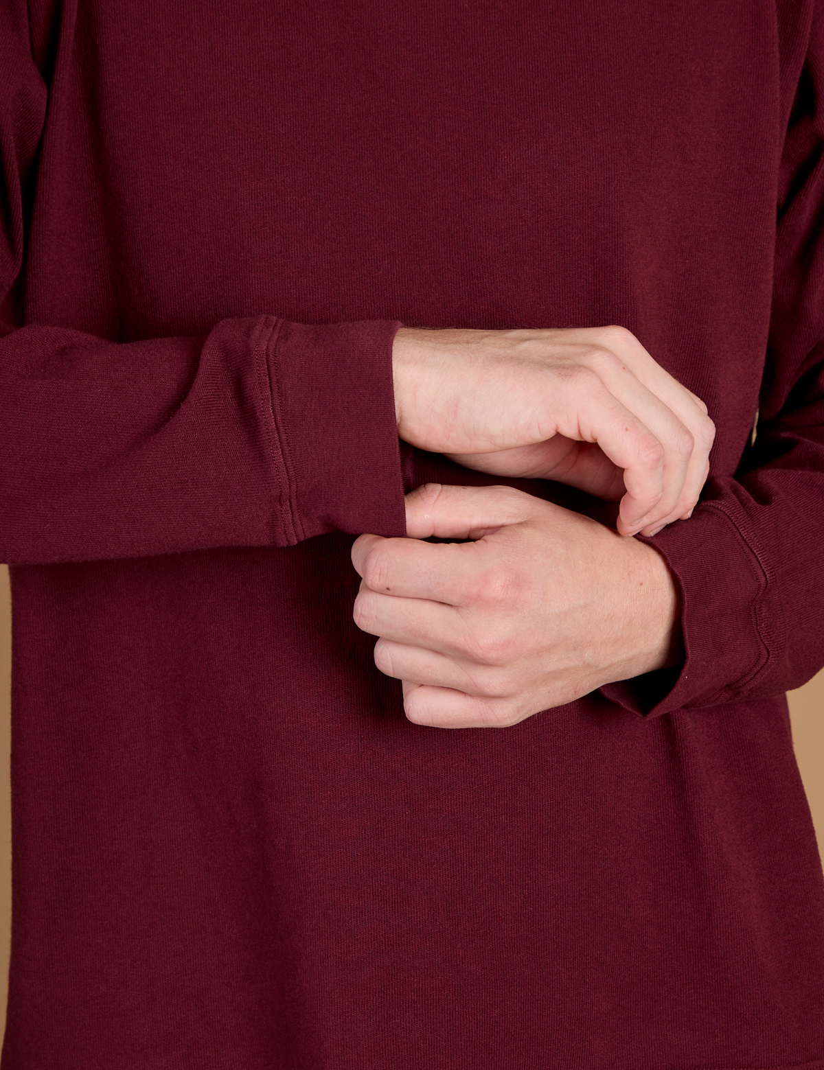 Close up of the Red Wine Long Sleeve Burly Tee's sleeves worn by Quinn