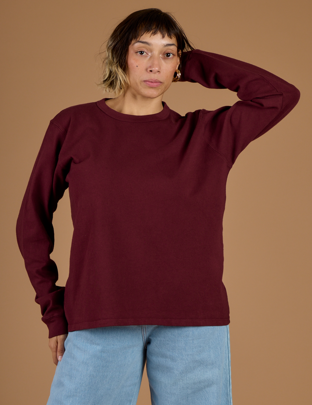 Tiara is 5'4" and wearing XS Red Wine Long Sleeve Burly Tee