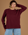 Tiara is 5'4" and wearing XS Red Wine Long Sleeve Burly Tee
