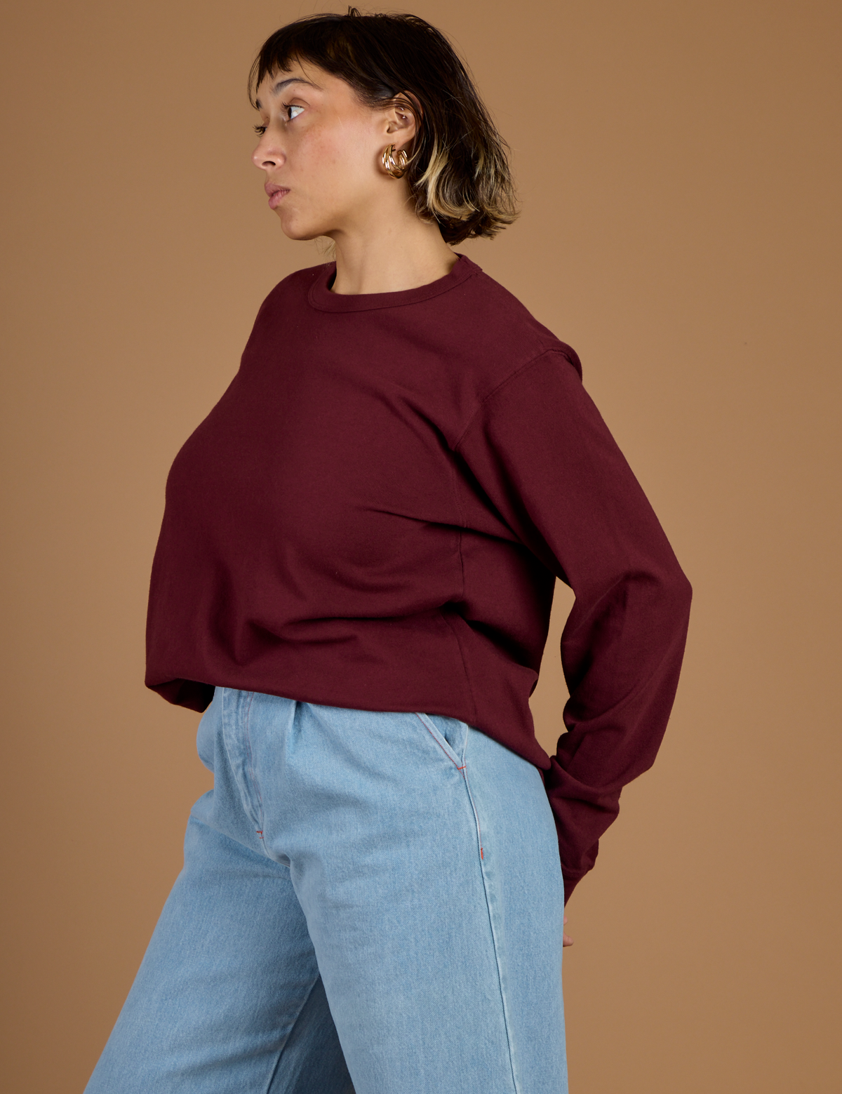 Side view of Tiara wearing the Red Wine Long Sleeve Burly Tee