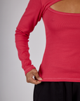 Close up of the hem on the Hot Pink Long Sleeve Porthole Tee worn by Mika