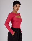 Angled side view of the Hot Pink Long Sleeve Porthole Tee on Mika