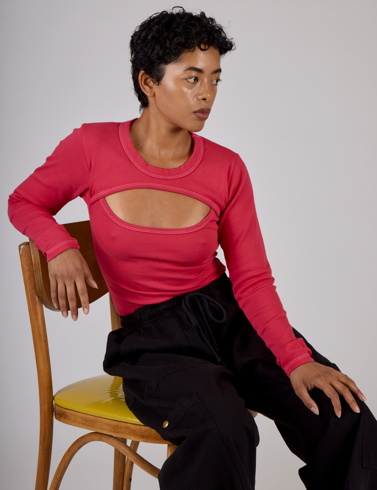 Mika is 5'3" and wearing the Hot Pink Long Sleeve Porthole Tee with Black Drop Pocket Pants