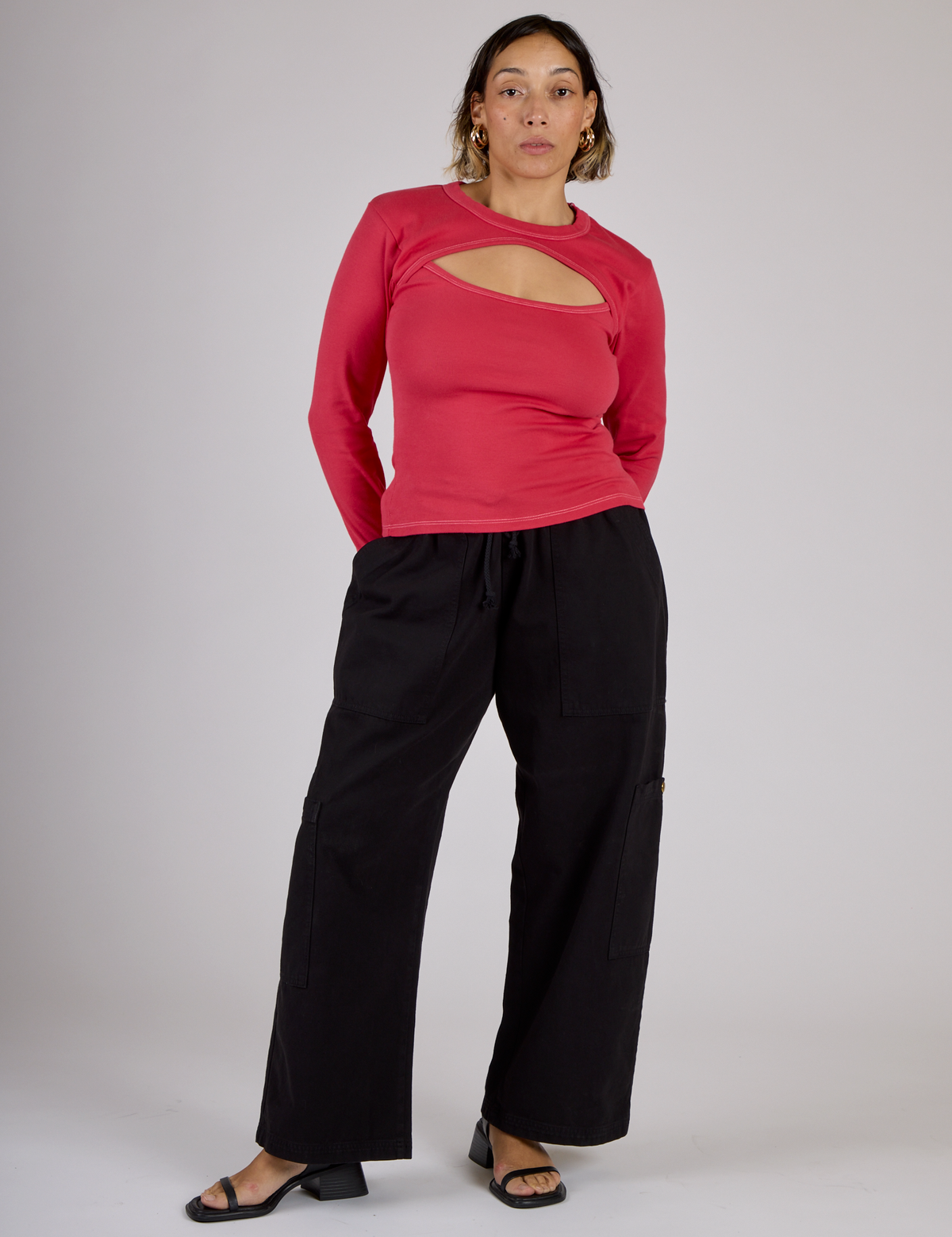 Tiara is wearing the Hot Pink Long Sleeve Porthole Tee with Black Drop Pocket Pants