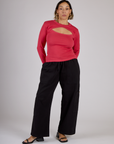 Tiara is wearing the Hot Pink Long Sleeve Porthole Tee with Black Drop Pocket Pants