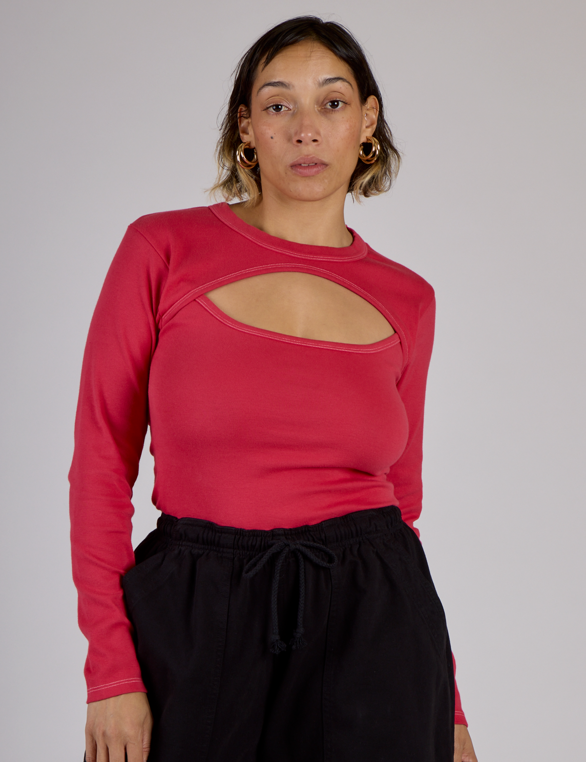 Tiara is 5'4" and wearing XS Hot Pink Long Sleeve Porthole Tee