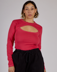 Tiara is 5'4" and wearing XS Hot Pink Long Sleeve Porthole Tee