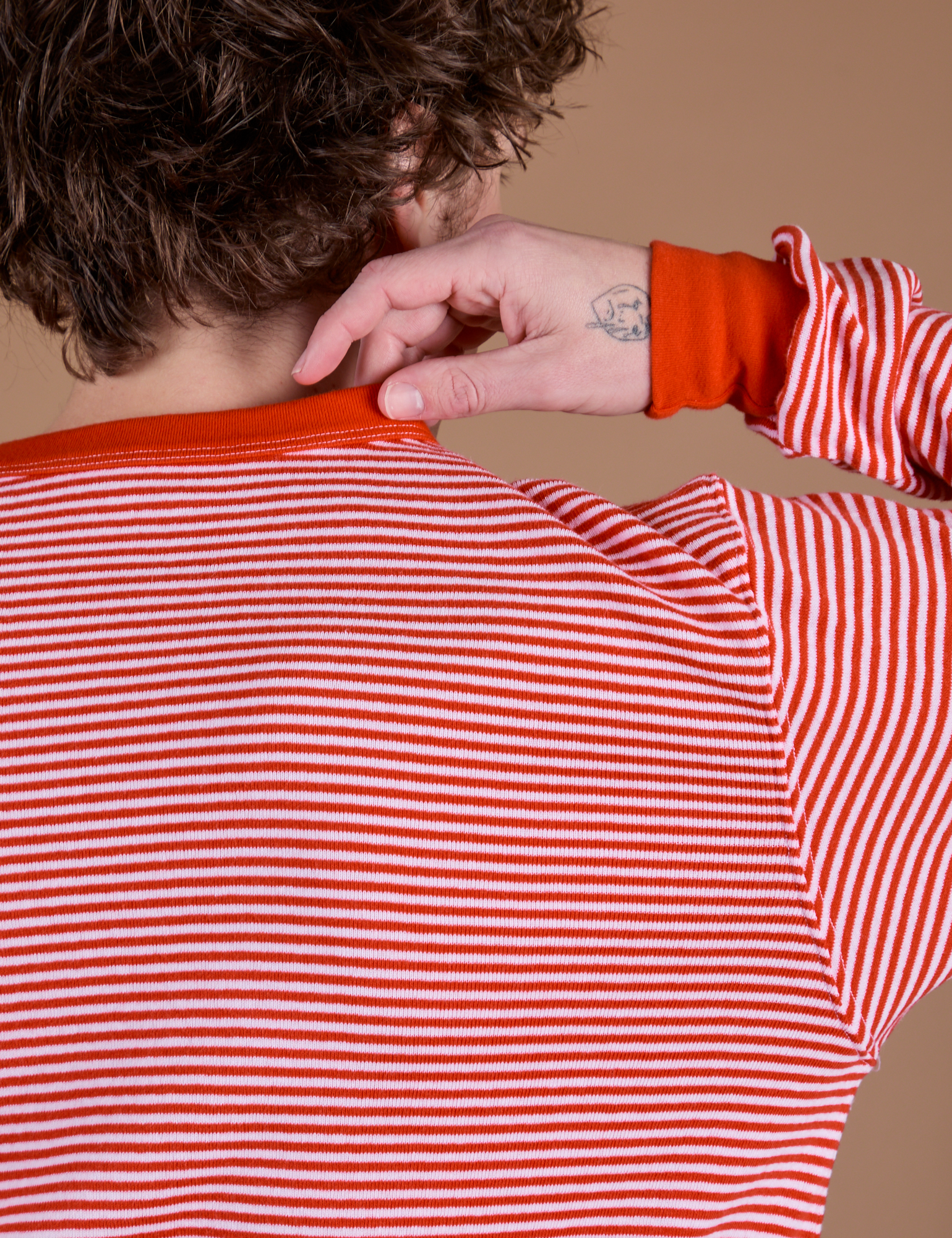 Long Sleeve Burly Tee in Red/White Stripe back shoulder close up on Quinn