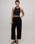 Alex is wearing the Basic Black Deep Cut Racerback with Black Drop Pocket Pants