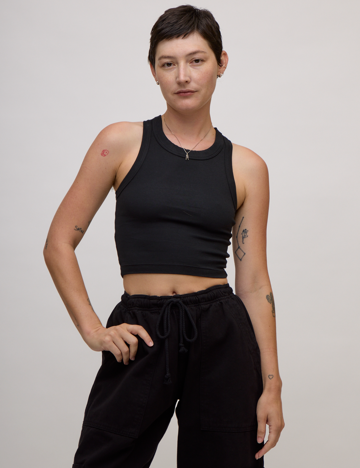 Alex is 5'8" and wearing P Basic Black Deep Cut Racerback
