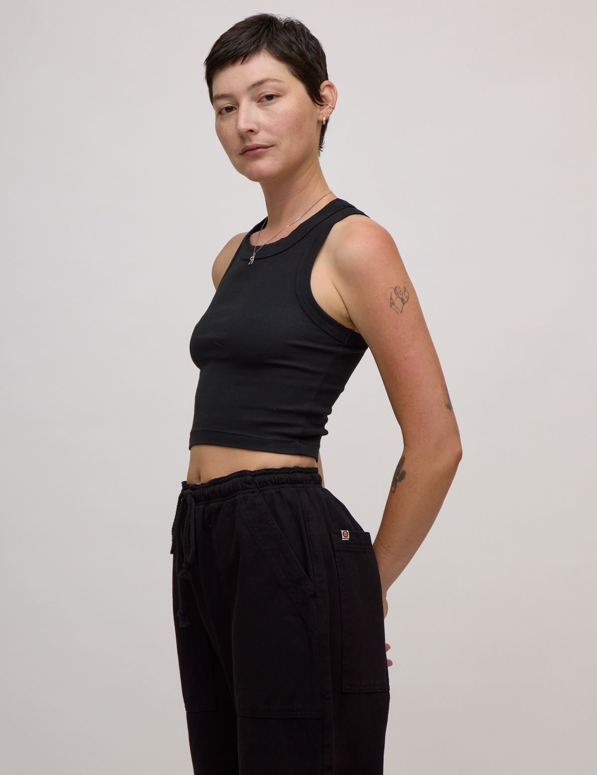 Angled side view of the Basic Black Deep Cut Racerback 