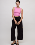 Alex is wearing the P Bubblegum Pink Deep Cut Racerback with Black Drop Pocket Pants