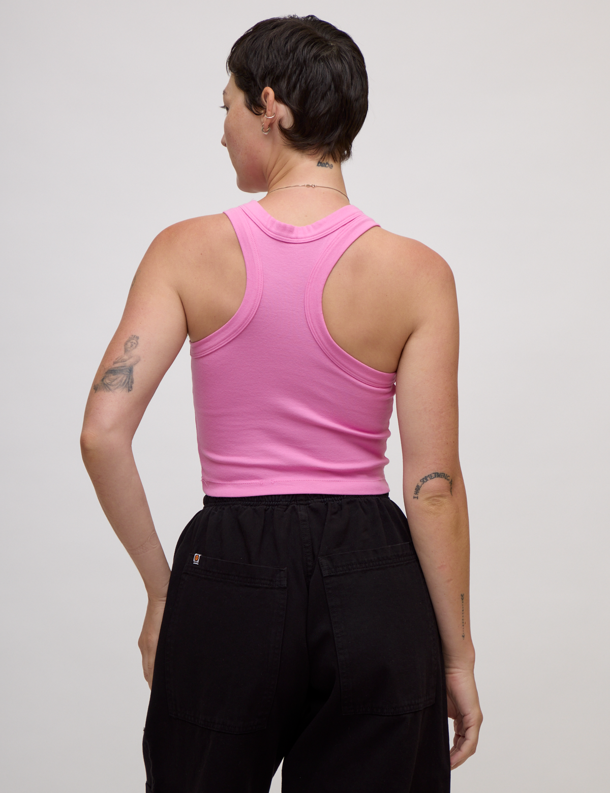 Back view of Alex wearing the P Bubblegum Pink Deep Cut Racerback