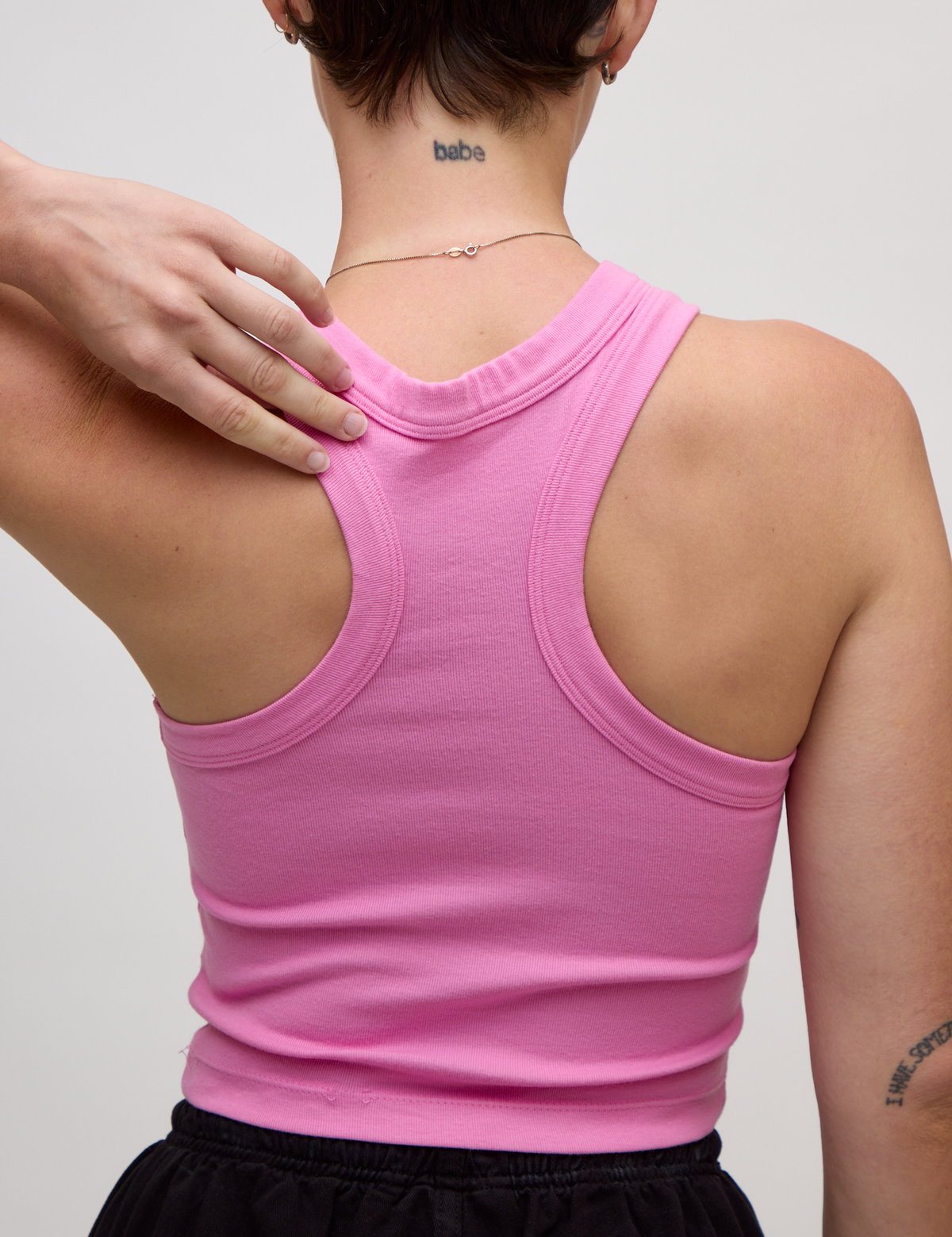 Close up back view of the P Bubblegum Pink Deep Cut Racerback on Alex