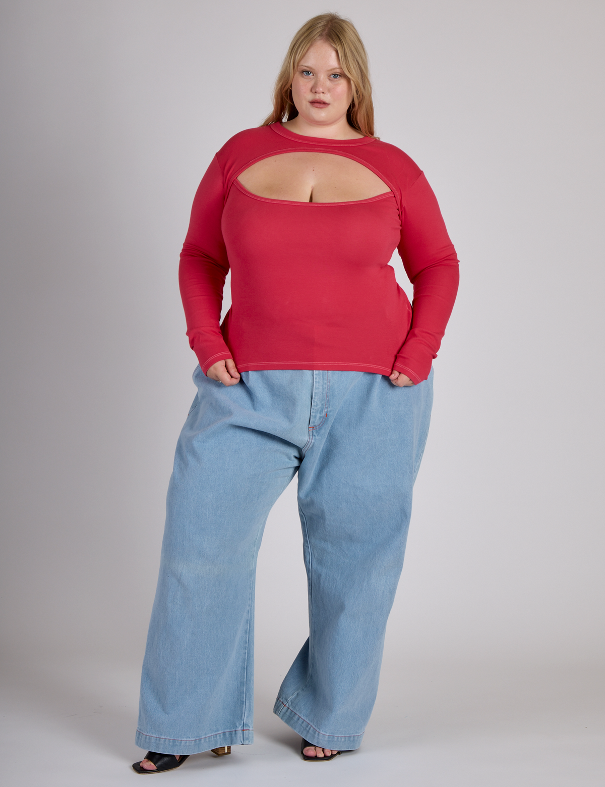Juliet wearing the Hot Pink Long Sleeve Porthole Tee with Light Wash Wide Leg Denim Trousers