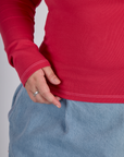 Close up of the hem on the Hot Pink Long Sleeve Porthole Tee worn by Juliet