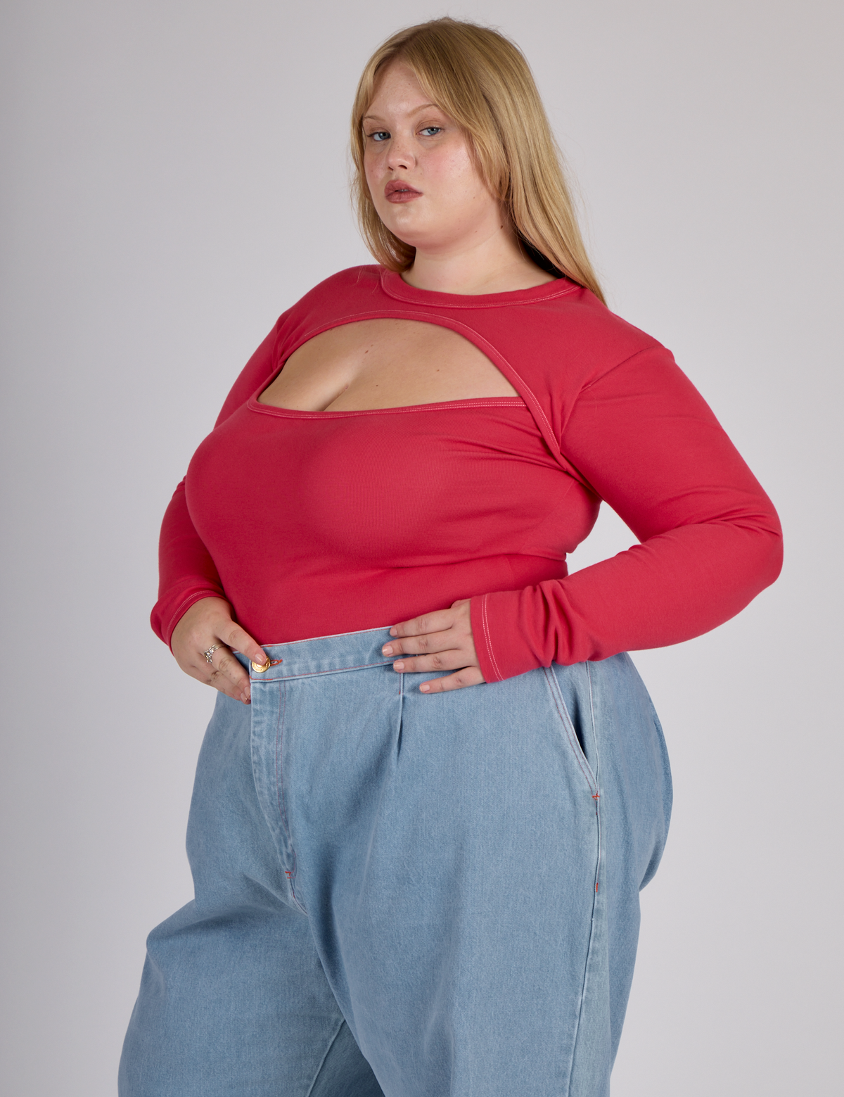 Angled side view of the Hot Pink Long Sleeve Porthole Tee worn by Juliet