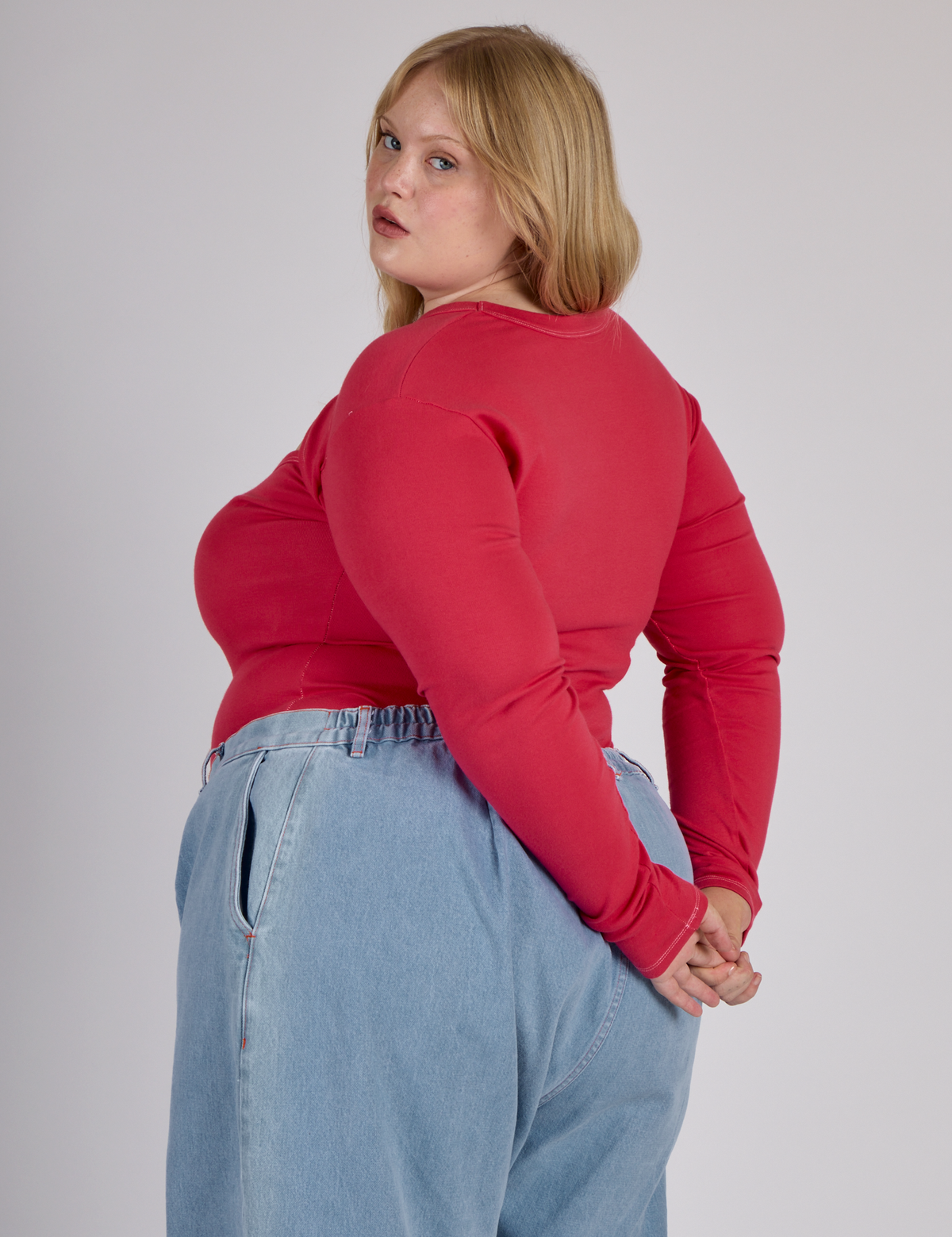Angled back view of the the Hot Pink Long Sleeve Porthole Tee on Juliet