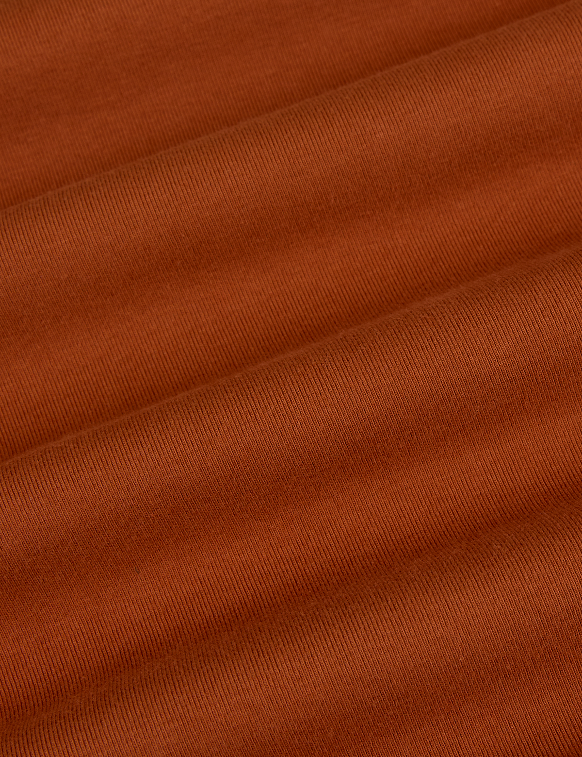 Fabric close up of the Burnt Terracotta Long Sleeve Baby Tee