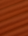 Fabric close up of the Burnt Terracotta Long Sleeve Baby Tee