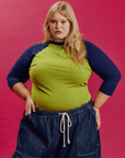 Juliet is 5'7" and wearing L Gross Green/Navy Colorblock Raglan Tee