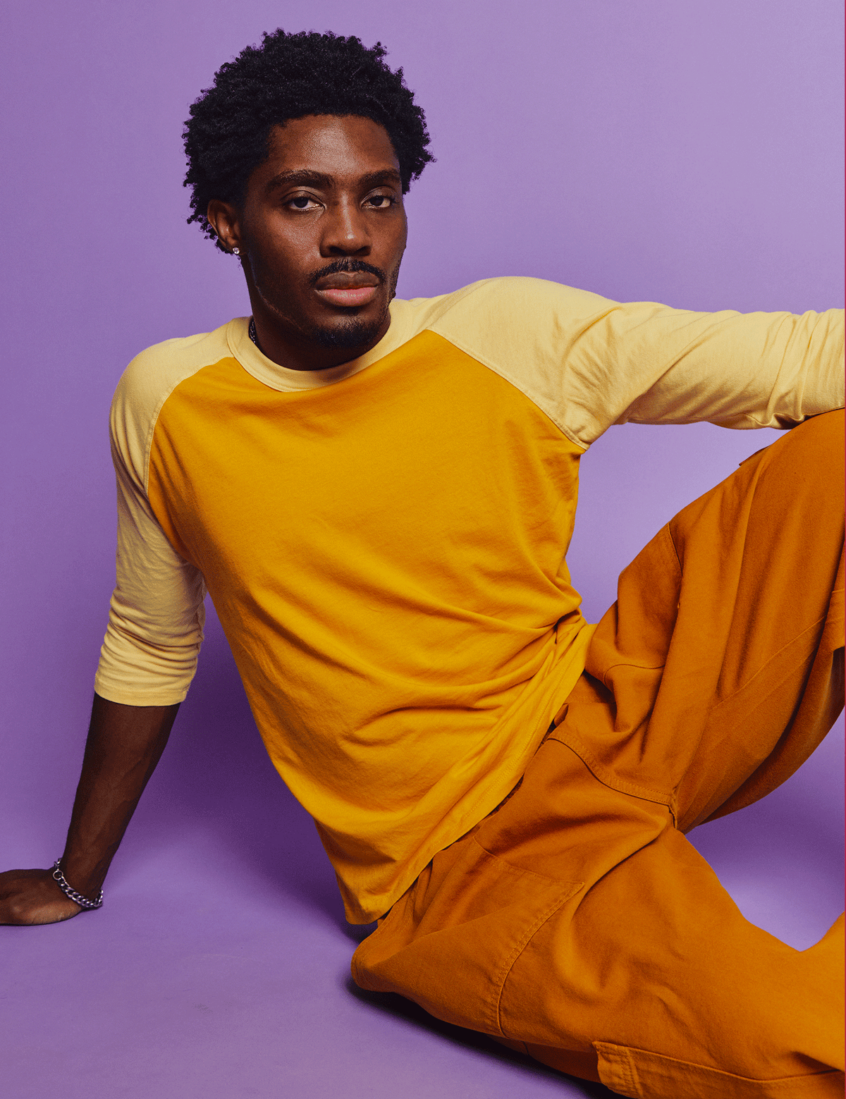 Isaac is 5'10" and wearing M Mustard Yellow/Butter Raglan Tee