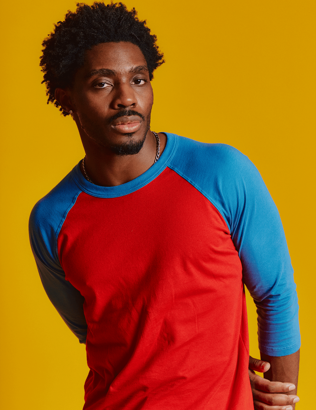 Isaac is 5'10" and wearing M Mustang Red/Blue Colorblock Raglan Tee
