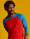 Isaac is 5'10" and wearing M Mustang Red/Blue Colorblock Raglan Tee