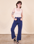 Hana is 5'3" and wearing XXS Petite Western Pants in Navy paired with a vintage off-white Tank Top
