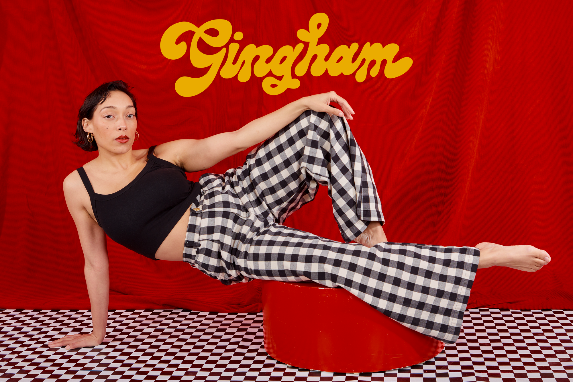 Tiara is wearing Wide Leg Trousers in Big Gingham paired with a black Cropped Cami