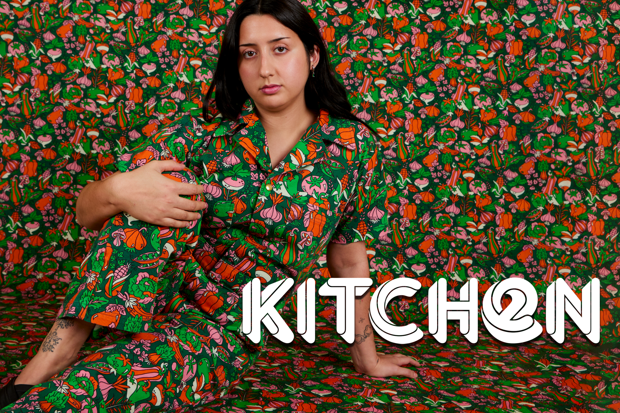 Betty is wearing a Short Sleeve Jumpsuit in Kitchen Print