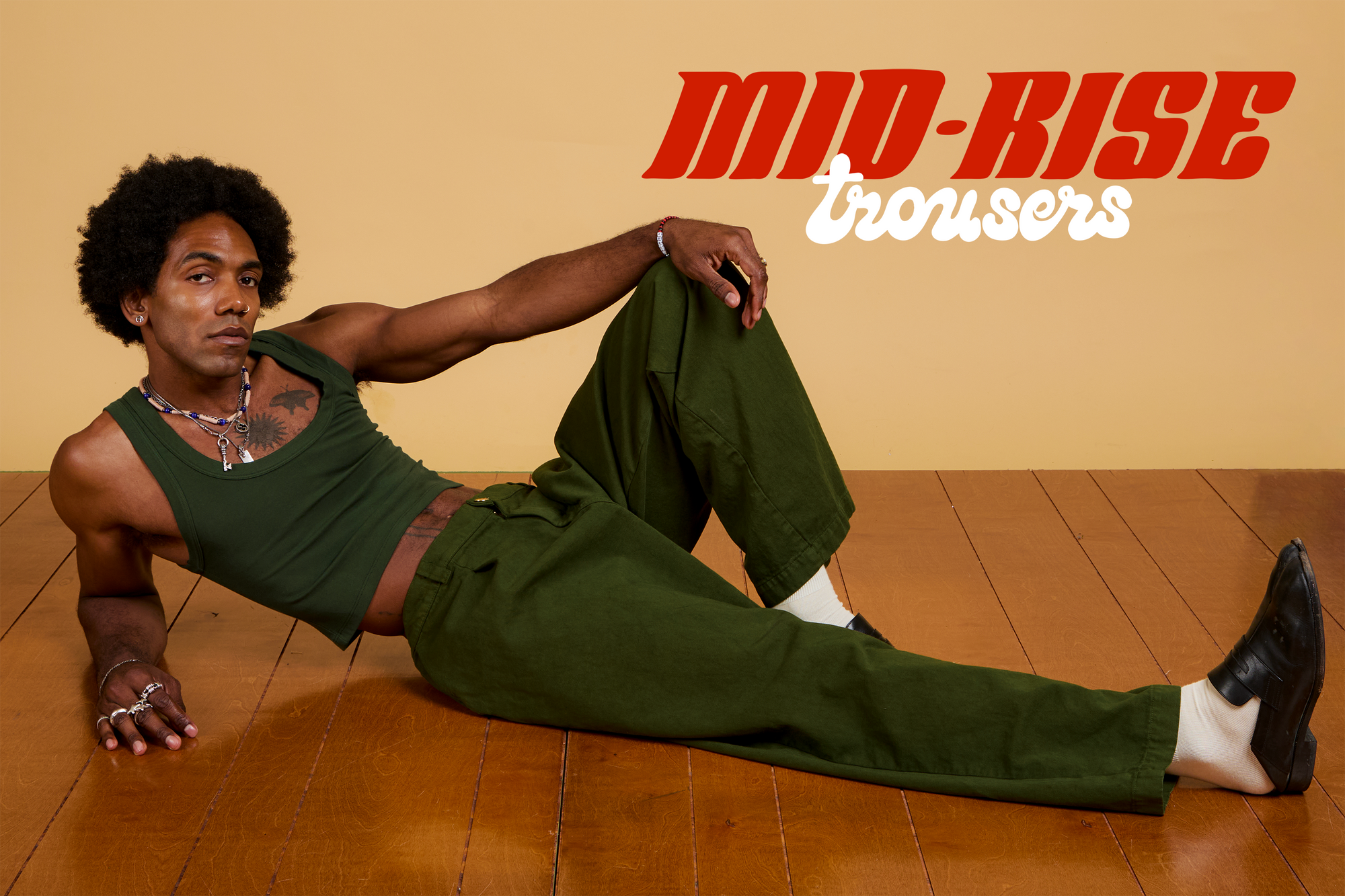 Jerrod is wearing Baggy Mid-Rise Trousers in Evergreen paired with a Cropped Tank in Swamp Green.
