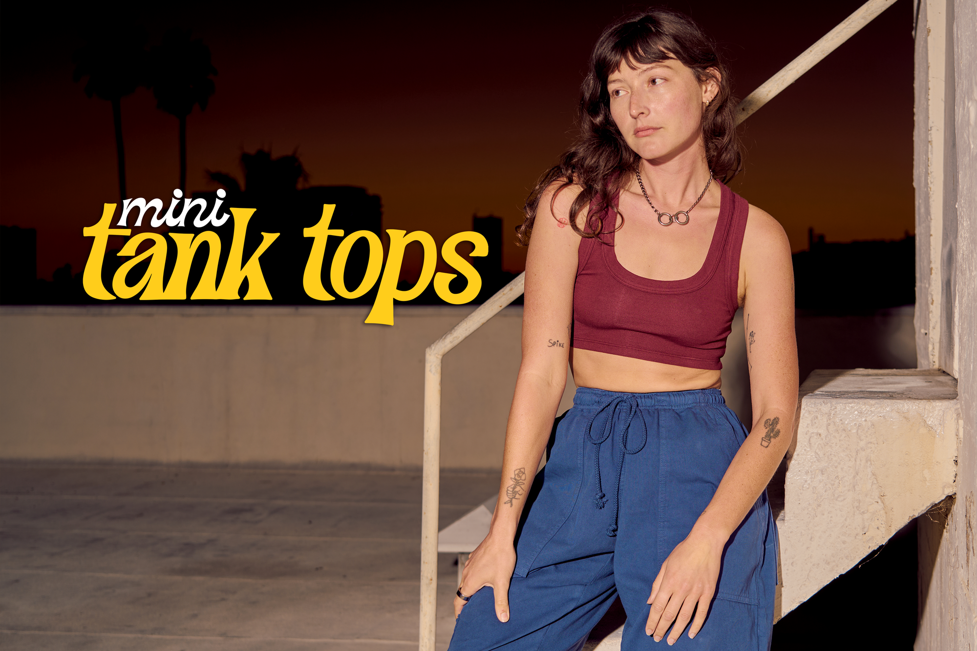 Alex is wearing red wine Mini tank paired with French blue Drop Pocket Cargo Pants