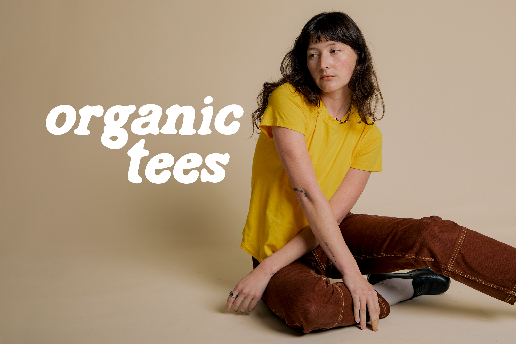 Alex is wearing the Organic Vintage Tee in Sunshine Yellow paired with Fudgesicle Brown Carpenter 